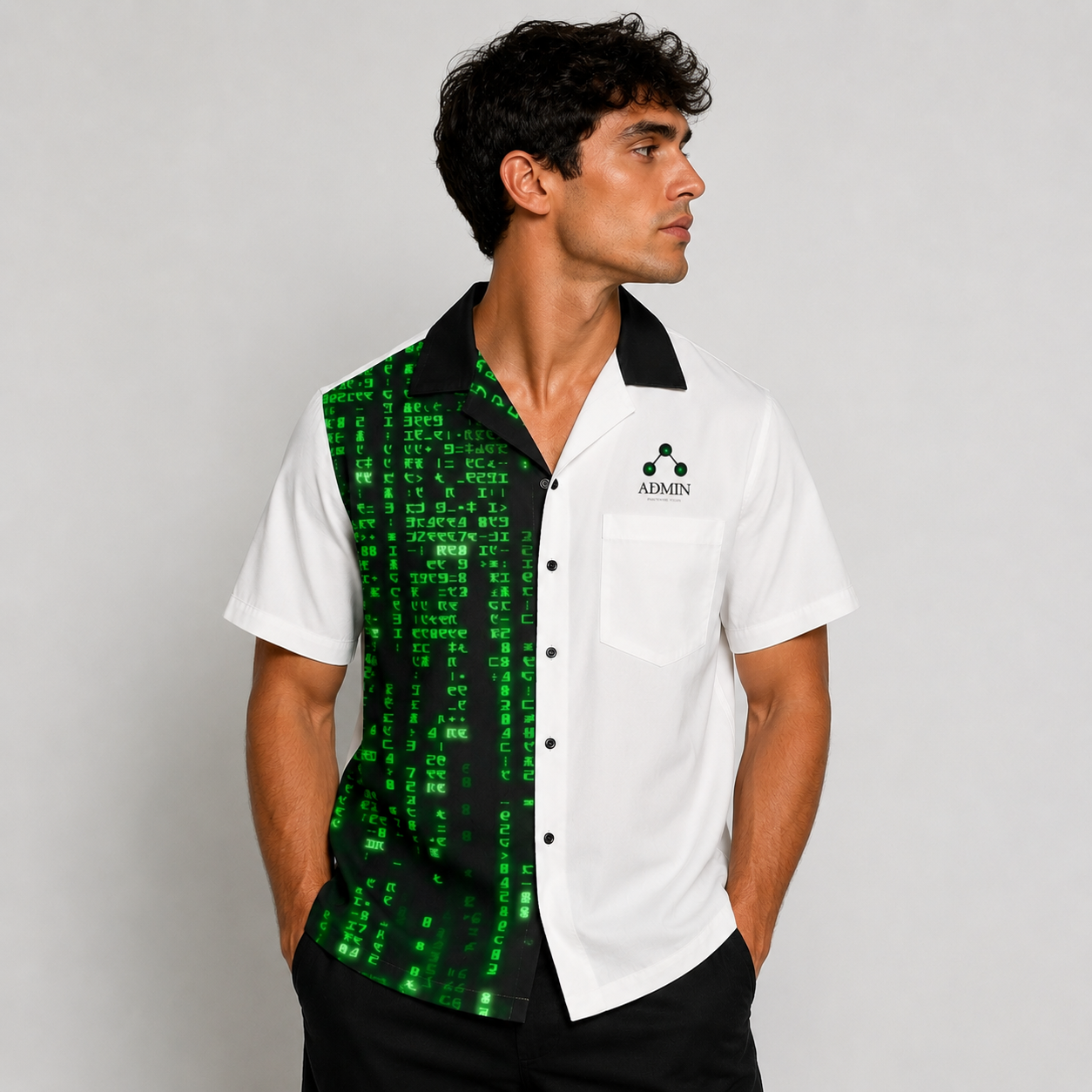 A man wearing a short-sleeve button-up shirt with a split design: one half is solid white with a black collar and chest logo, and the other half features a green digital matrix-style print on black. The brand name 'ADMIN' is visible on the chest pocket.