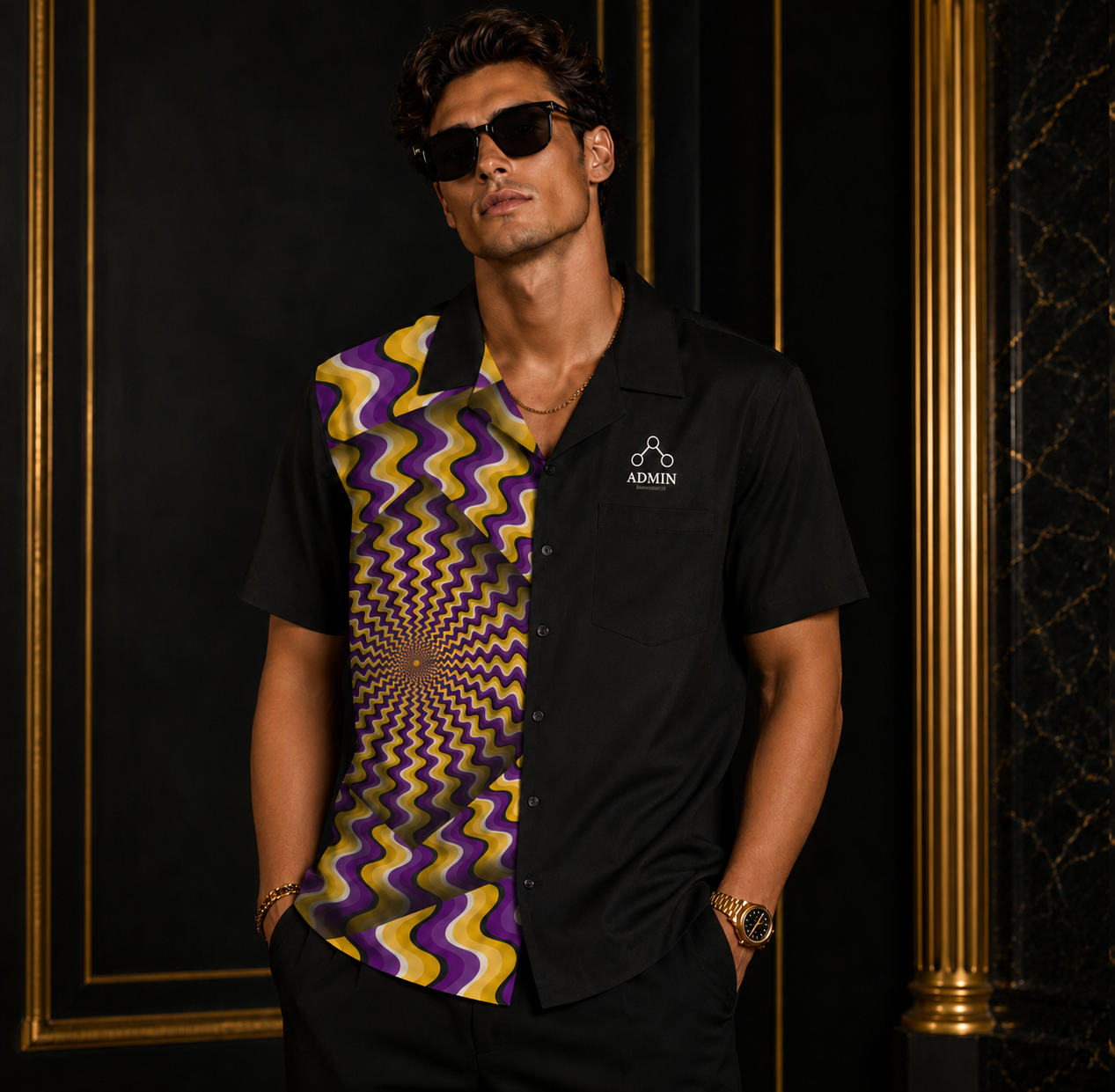 A man wearing a black short-sleeve button-up shirt with a bold purple and yellow wavy optical illusion pattern on the right side, styled with black sunglasses and standing against a dark background with gold trim.